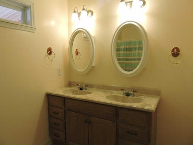 1406 Mud Creek Road Morrison, TN 37357 - Photo 9 of 20 a bathroom with a granite countertop sink a mirror and shower