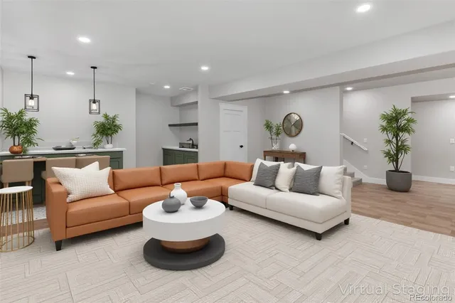 a living room with furniture potted plant and a chandelier