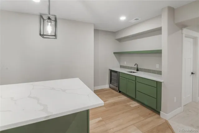a kitchen with a refrigerator and a sink