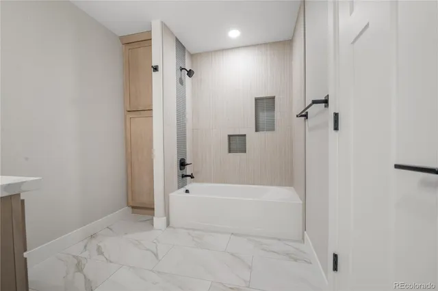 a bathroom with a bathtub and a shower