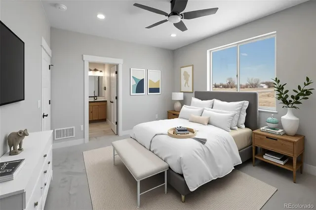 a bedroom with a large bed and a chandelier