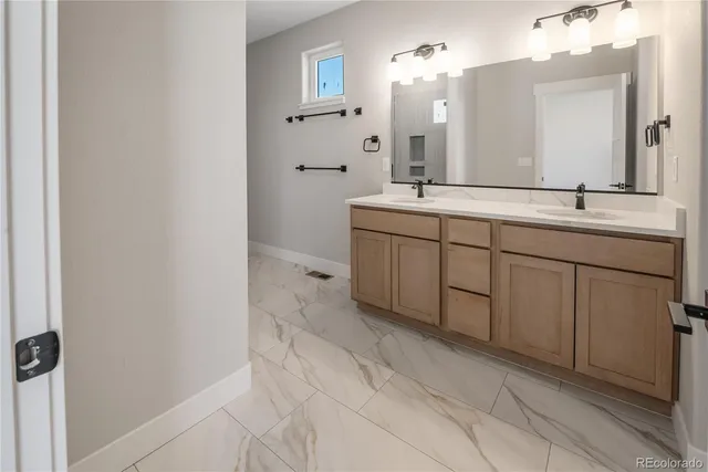 a spacious bathroom with a double vanity sink and a mirror