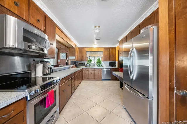 a kitchen with stainless steel appliances granite countertop a sink and cabinets