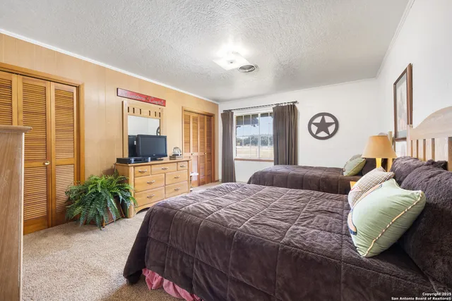 a bedroom with a bed chair and a window