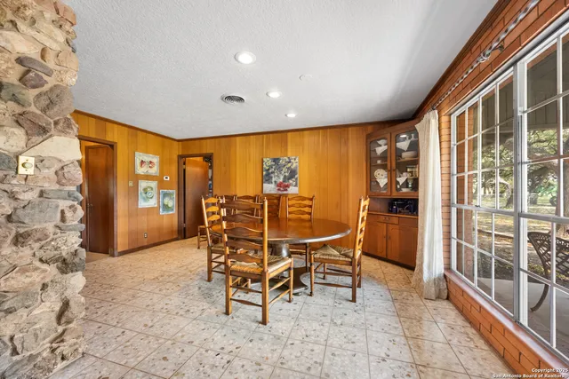 a bathroom with a sink a granite top and a mirror