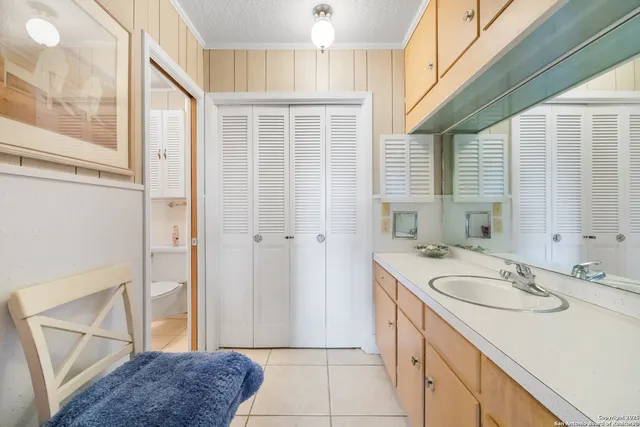 a view of a house with a yard and tree s