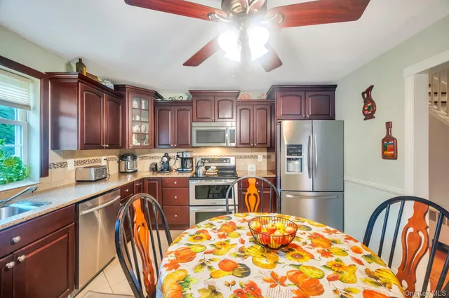 a kitchen with stainless steel appliances granite countertop a refrigerator and a stove top oven