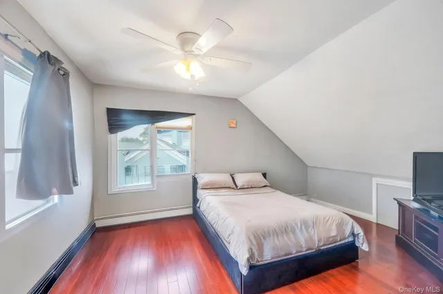 a bedroom with a large bed and a tv