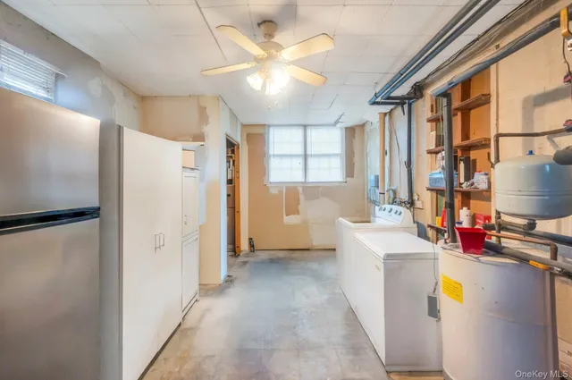 a view of a kitchen with fridge and a sink