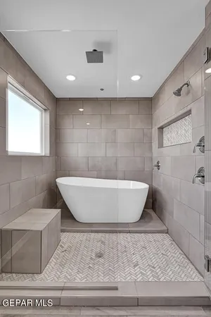 a bathroom with a bathtub and shower