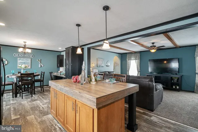 a open kitchen with stainless steel appliances granite countertop a stove refrigerator and cabinets