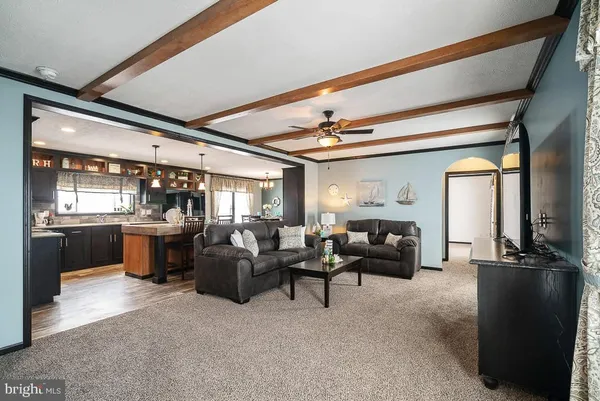 a living room with fireplace furniture and a large window