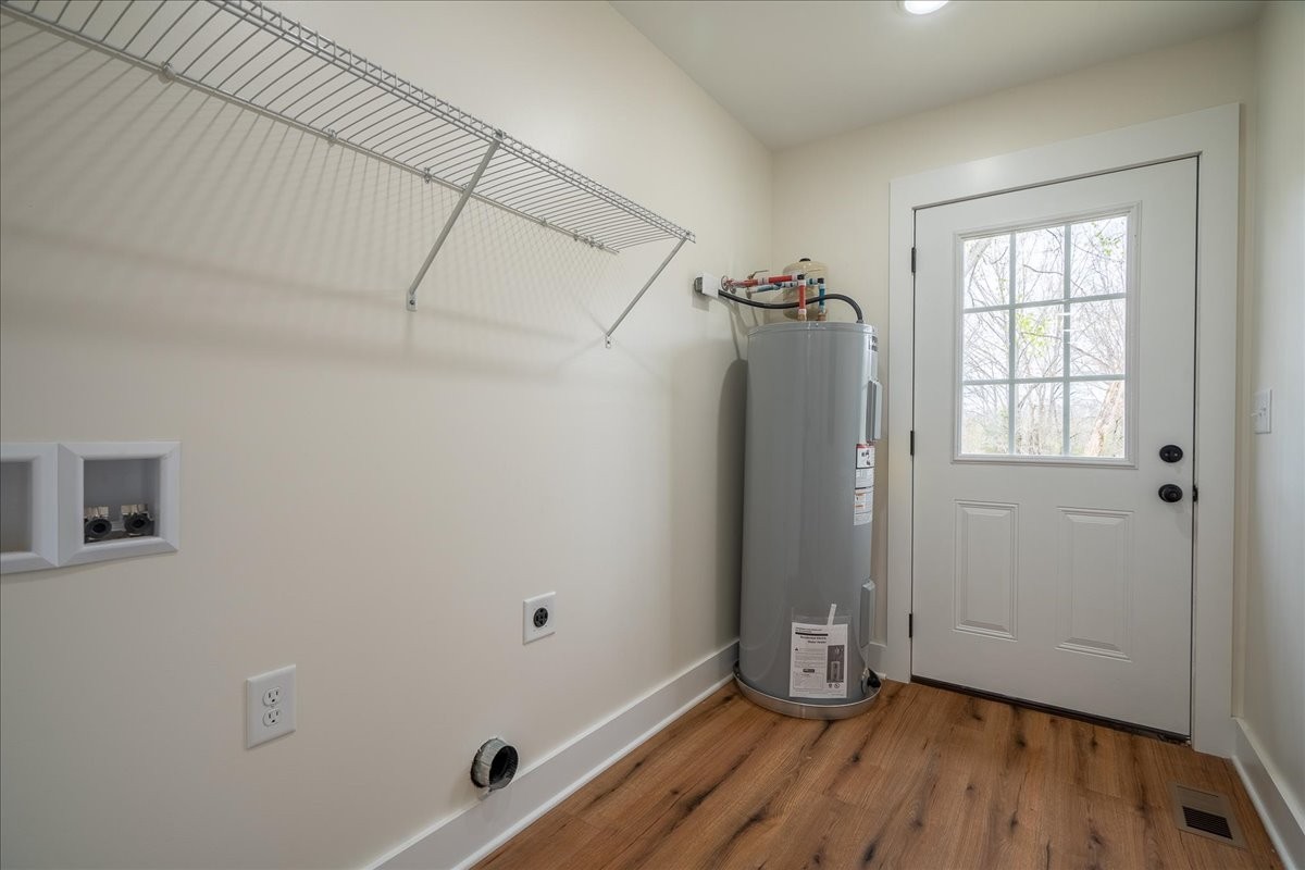 3987 Buffalo Road Summertown, TN 38483 - Photo 24 of 26 an empty room with wooden floor and windows