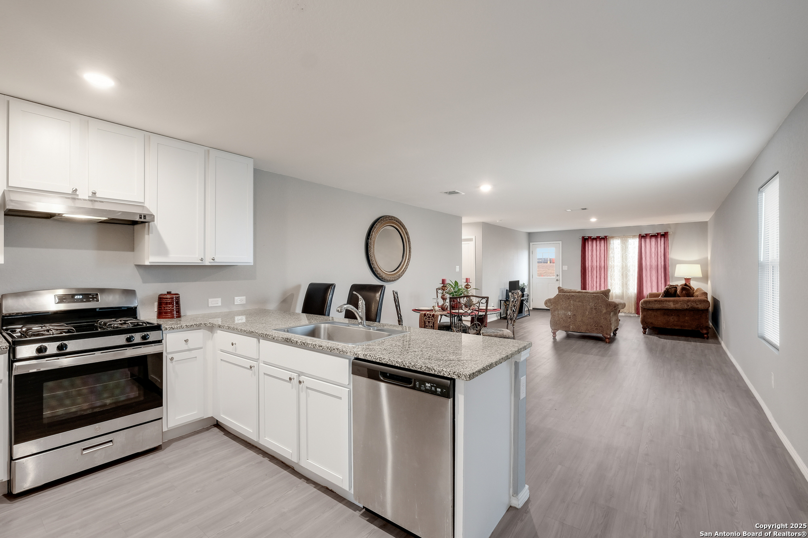 706 Ambush Ridge San Antonio, TX 78220 - Photo 7 of 21 a kitchen with a stove a sink and a refrigerator