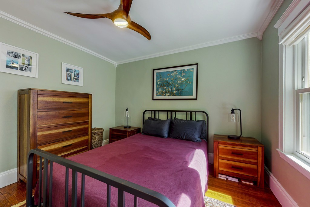 15 Sunset Road, Unit 15 Watertown, MA 02472 - Photo 18 of 25 a bedroom with a bed and a chandelier