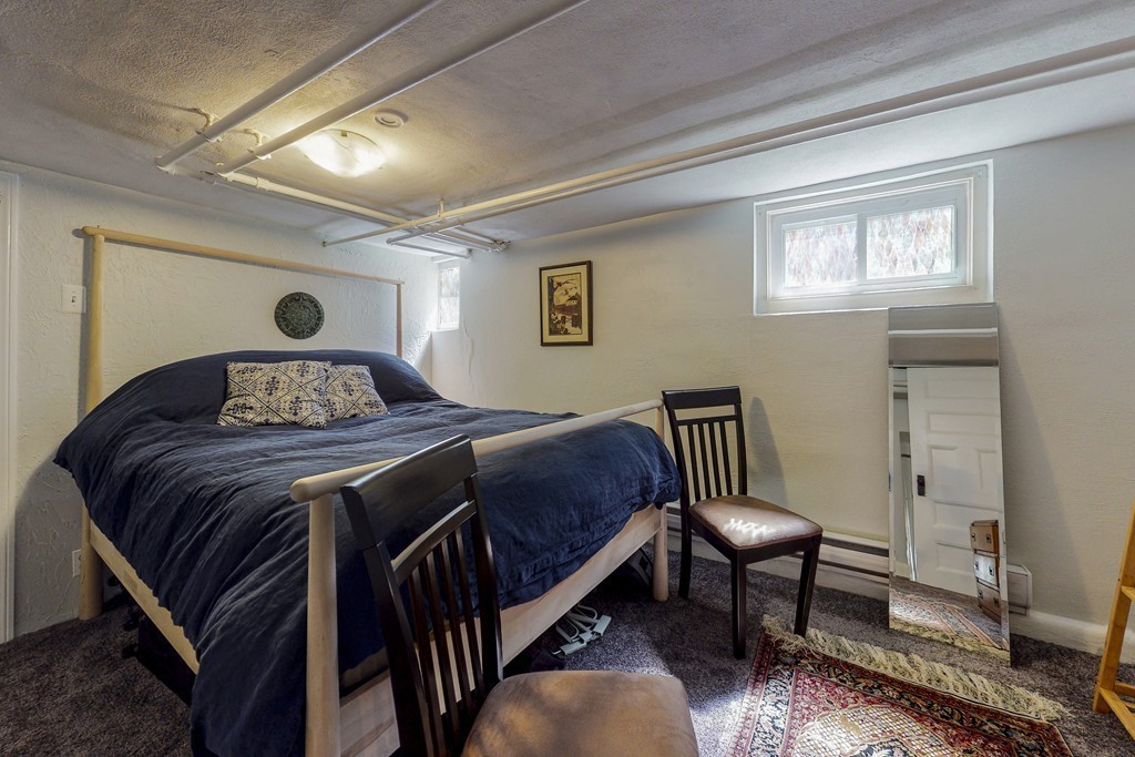 15 Sunset Road, Unit 15 Watertown, MA 02472 - Photo 23 of 25 a bedroom with a bed and wooden floor