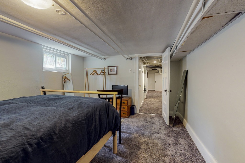 15 Sunset Road, Unit 15 Watertown, MA 02472 - Photo 24 of 25 a bed room with a bed and a refrigerator