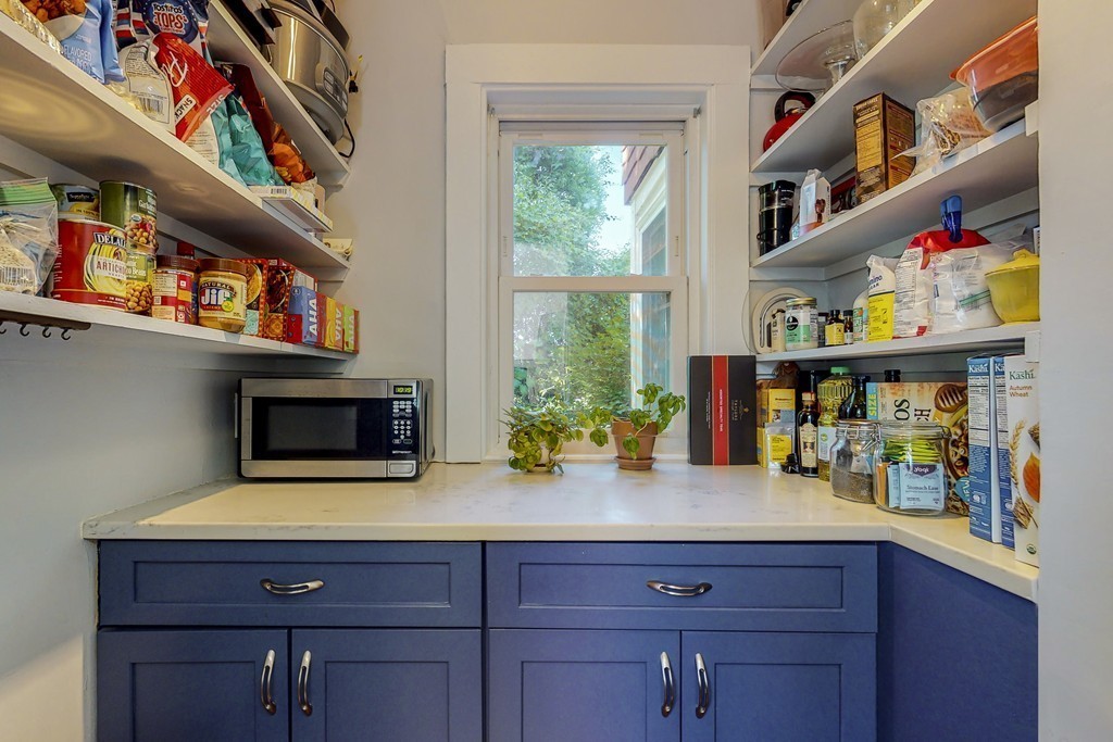 15 Sunset Road, Unit 15 Watertown, MA 02472 - Photo 10 of 25 a kitchen with wooden cabinets and a potted plant