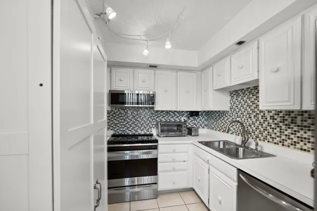 a kitchen with a sink and appliances