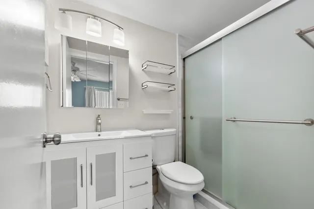 a bathroom with a sink toilet and shower