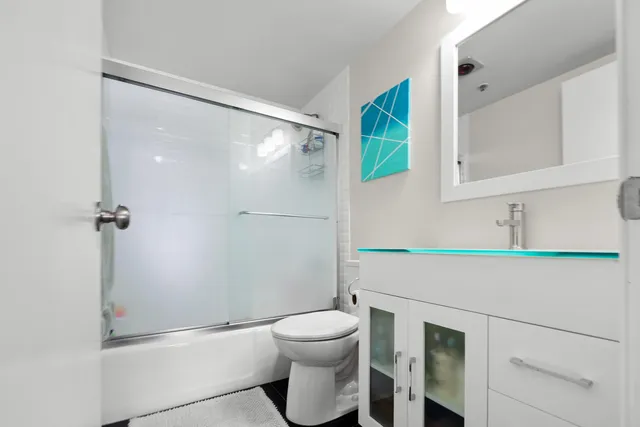 a bathroom with a toilet sink and shower
