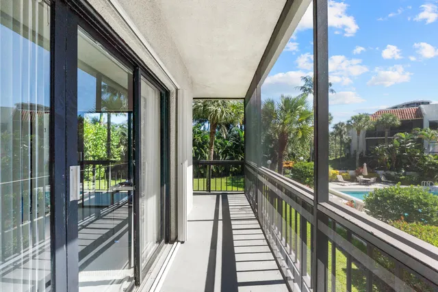 a view of a room with wooden floor and floor to ceiling window
