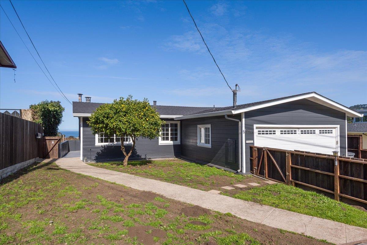 a view of a house with a yard and plants