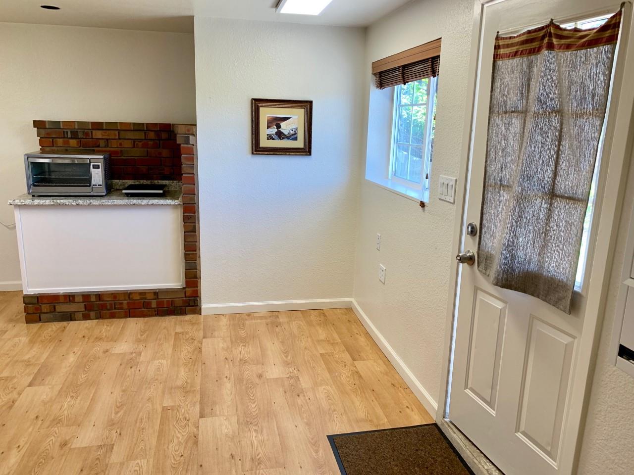 815 Edgemar Avenue Pacifica, CA 94044 - Photo 23 of 27 a view of hallway with wooden floor and flat screen tv