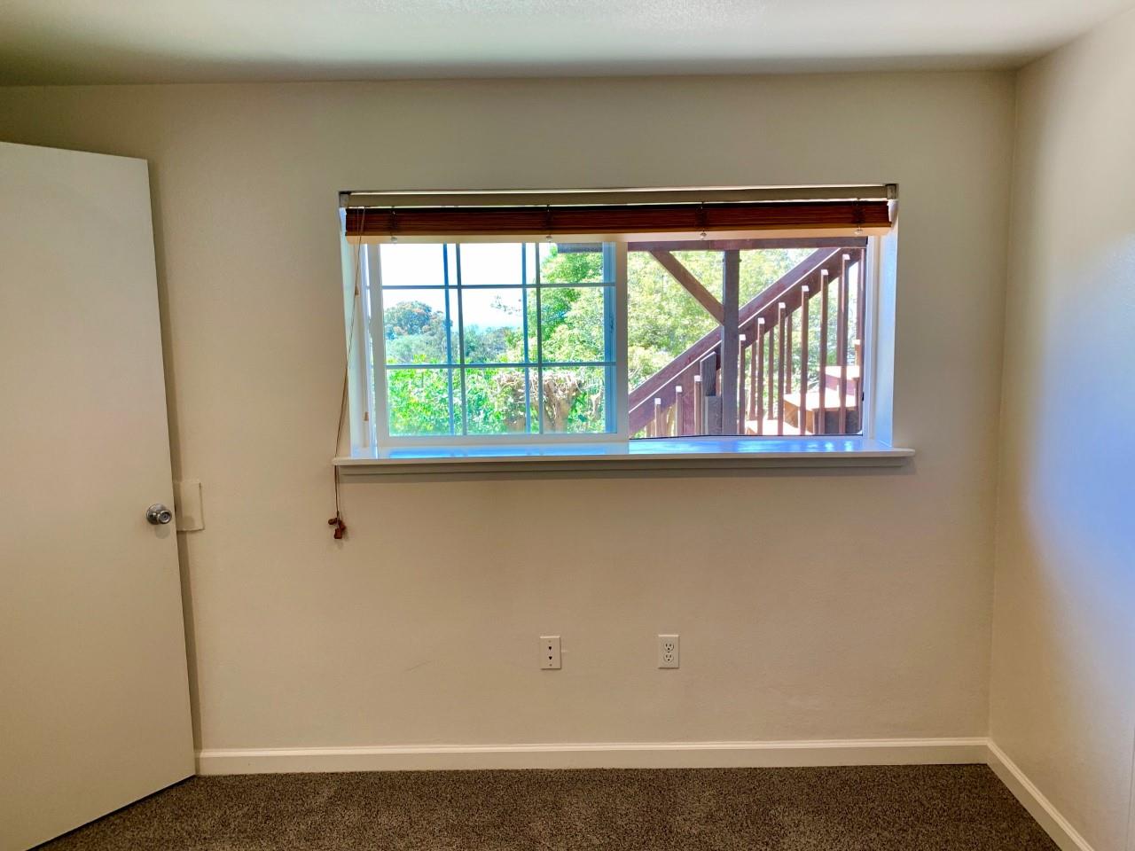 815 Edgemar Avenue Pacifica, CA 94044 - Photo 25 of 27 a view of a small space with wooden floor and a window