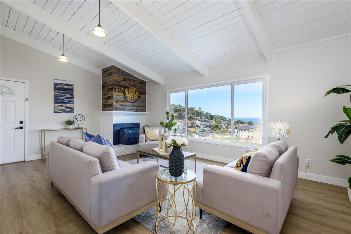 815 Edgemar Avenue Pacifica, CA 94044 - Photo 4 of 27 a living room with furniture fireplace and a large window