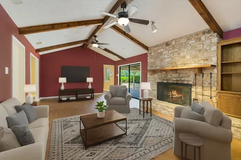 a living room with furniture and a fireplace