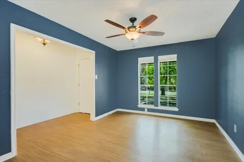 a view of a livingroom with a ceiling fan and window