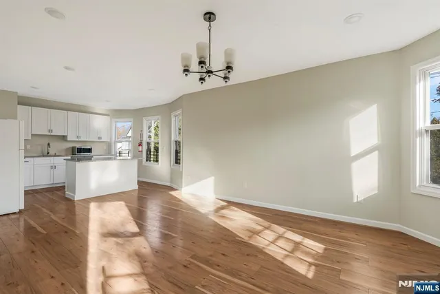 a view of a kitchen with wooden floor and a kitchen