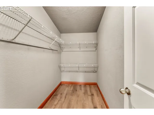 a bathroom with a granite countertop sink a mirror and a toilet