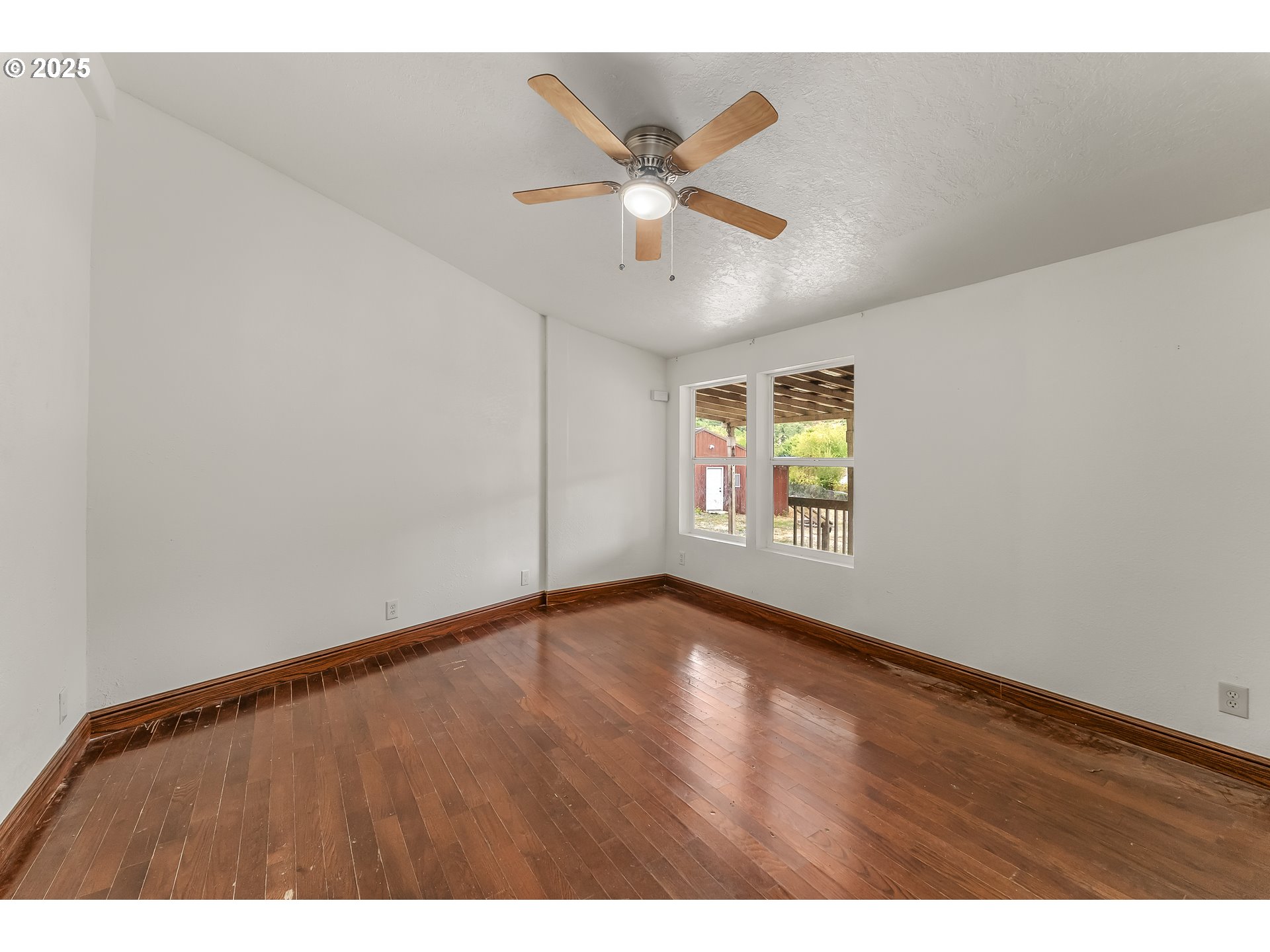 161 South Avenue Sutherlin, OR 97479 - Photo 18 of 45 a view of an empty room with wooden floor and a ceiling fan