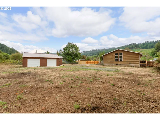 a house view with swimming pool and trees in the background
