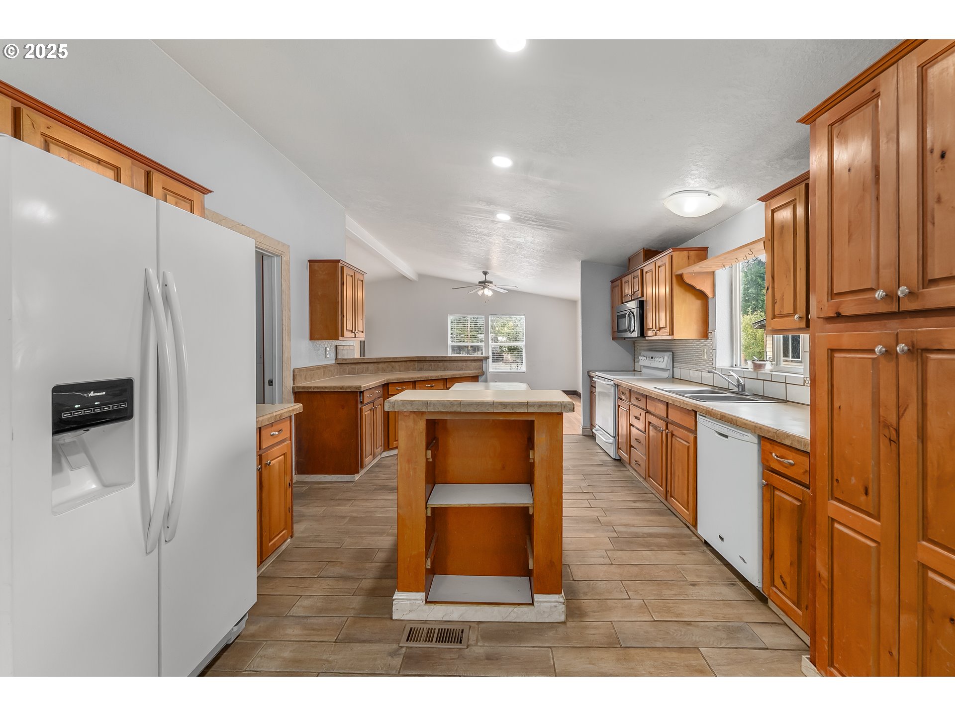 161 South Avenue Sutherlin, OR 97479 - Photo 9 of 45 a large kitchen with cabinets and stainless steel appliances