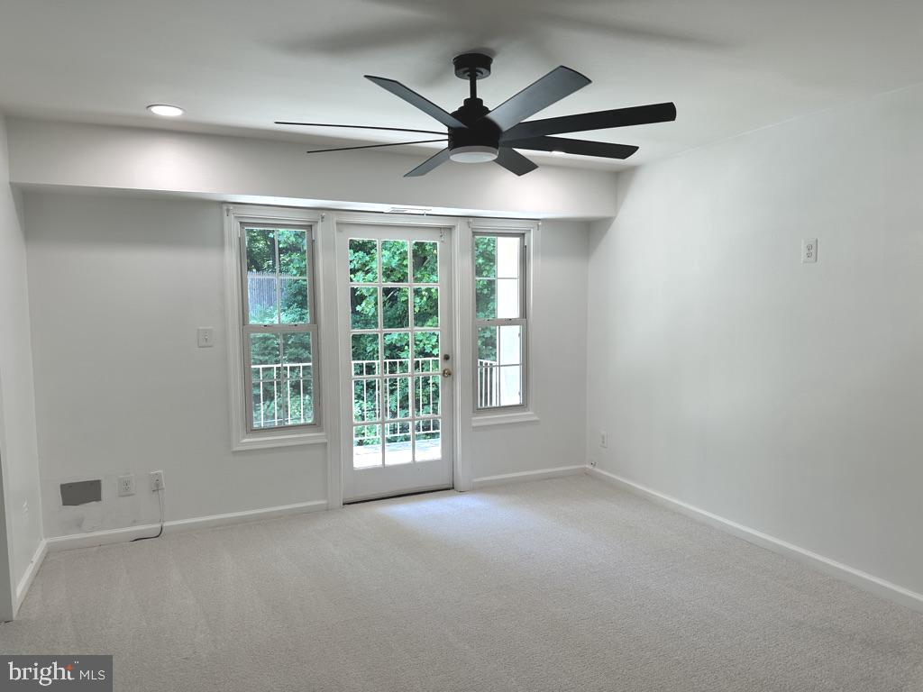 5900 Prince George Drive, Unit 333 Springfield, VA 22152 - Photo 3 of 31 an empty room with a ceiling fan and windows