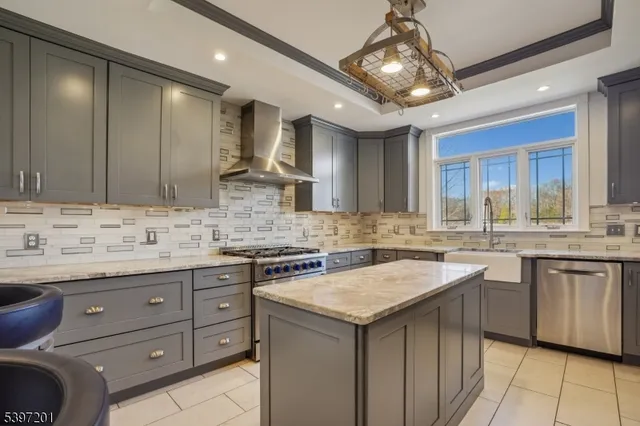 a kitchen with stainless steel appliances granite countertop a refrigerator and a stove