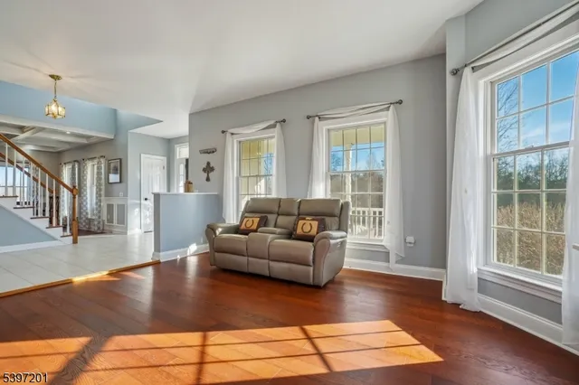 a dining room with furniture and a floor to ceiling window