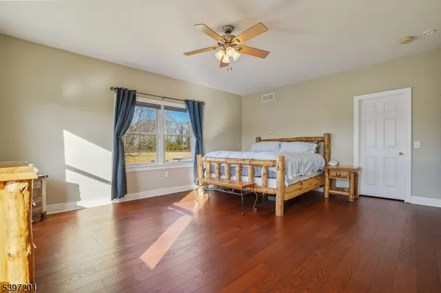 a spacious bathroom with a granite countertop sink and a mirror