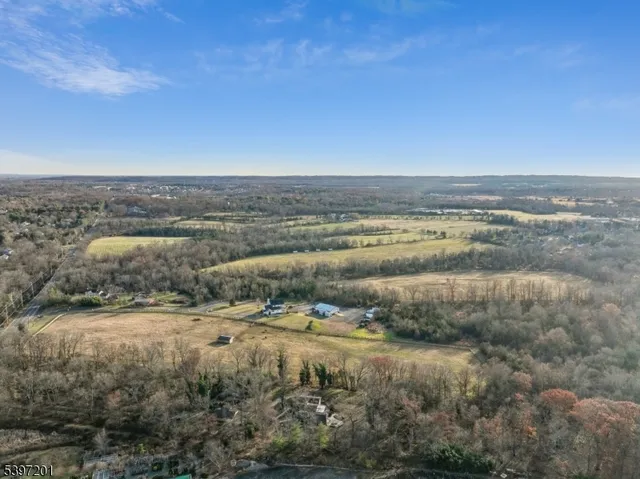 a view of a house with a yard and lake view