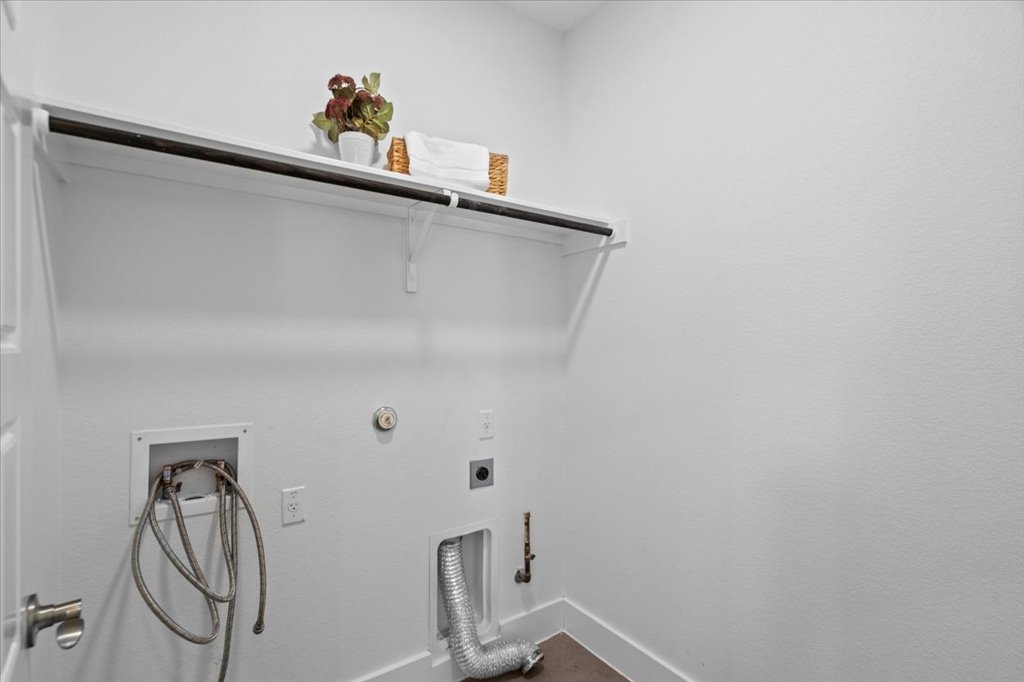 1765 Rowdy Loop, Unit 47 Leander, TX 78641 - Photo 21 of 40 A functional laundry area includes built-in overhead shelving and essential hookups.