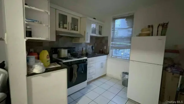 a kitchen with a sink and a refrigerator