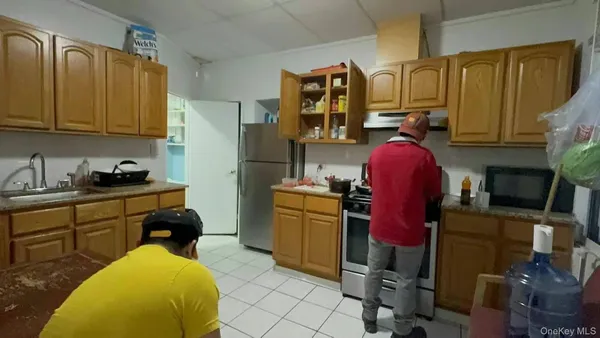 a kitchen with a refrigerator and sink