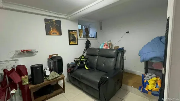 a living room with furniture and a lamp