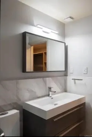 a bathroom with a toilet and a sink