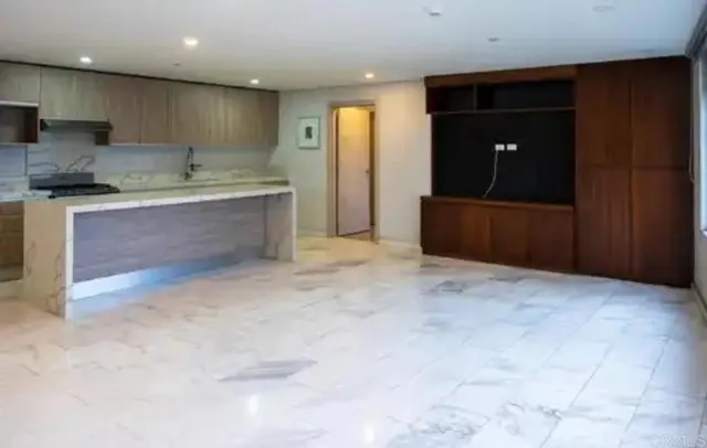 a kitchen with stainless steel appliances granite countertop a refrigerator and a sink