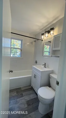 a bathroom with a toilet a sink and bathtub