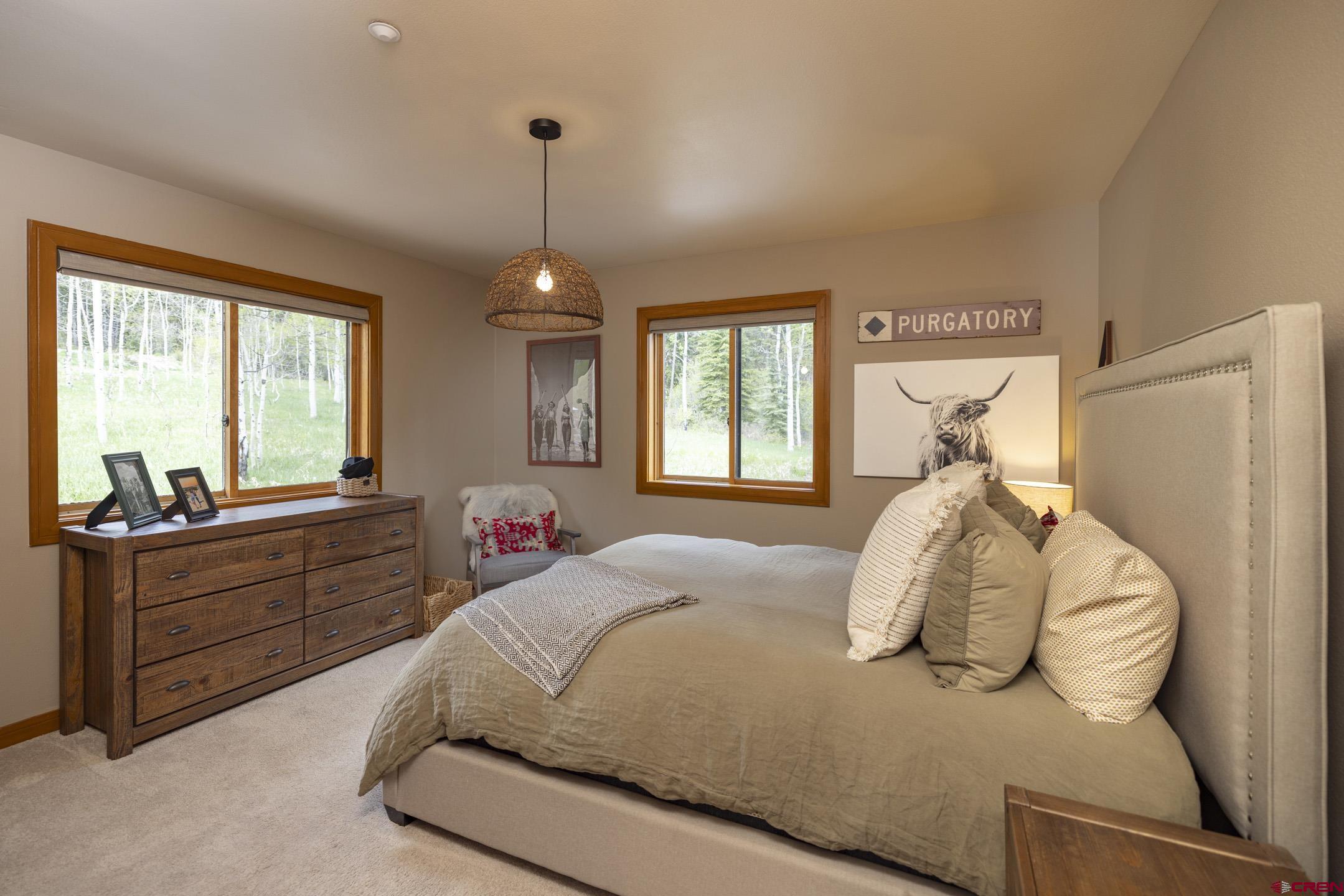 154 Falcon Ridge Road Durango, CO 81301 - Photo 20 of 42 a bed room with a bed and a furniture